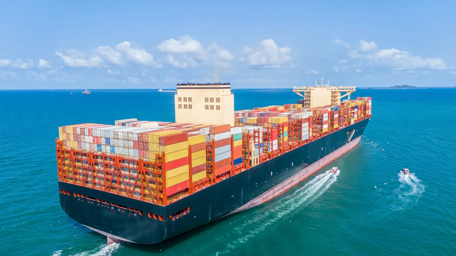A container ship crossing open blue sea